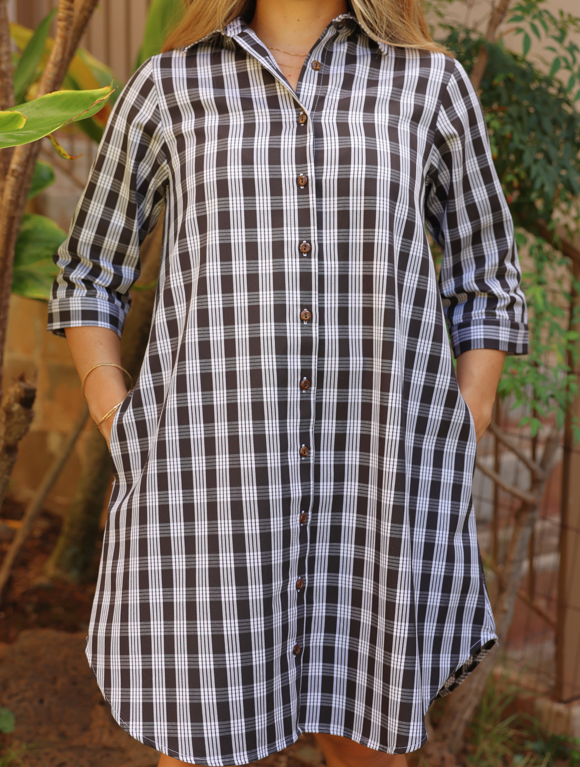 Moana Collection Dress in ʻAʻā features a classic Palaka pattern with button-down front. Sleeves rolled up, pockets visible.